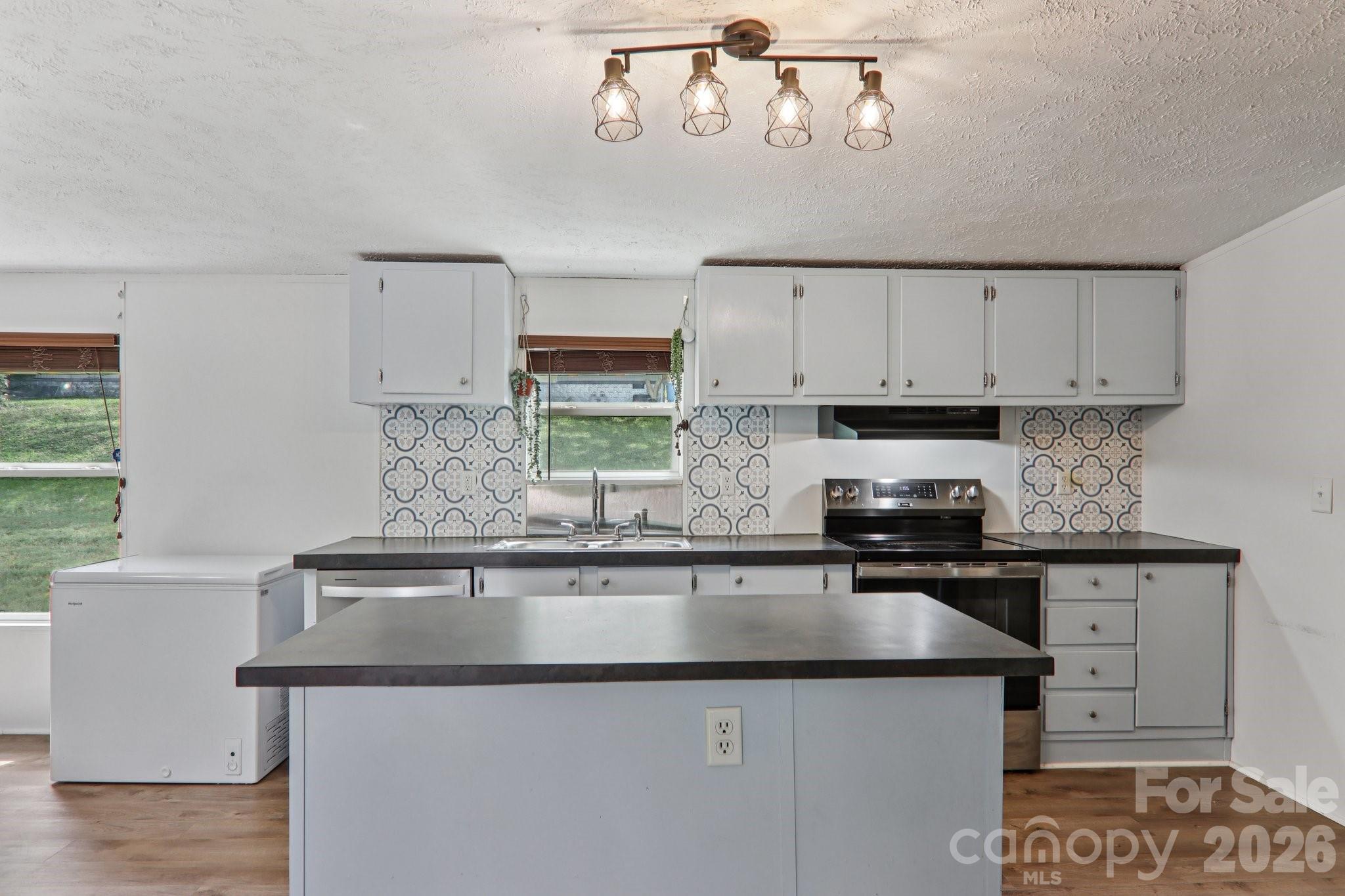 4 Sweet Birch Drive Alexander, NC 28701 - Photo 24 of 48 a kitchen with stainless steel appliances a sink a stove and a refrigerator