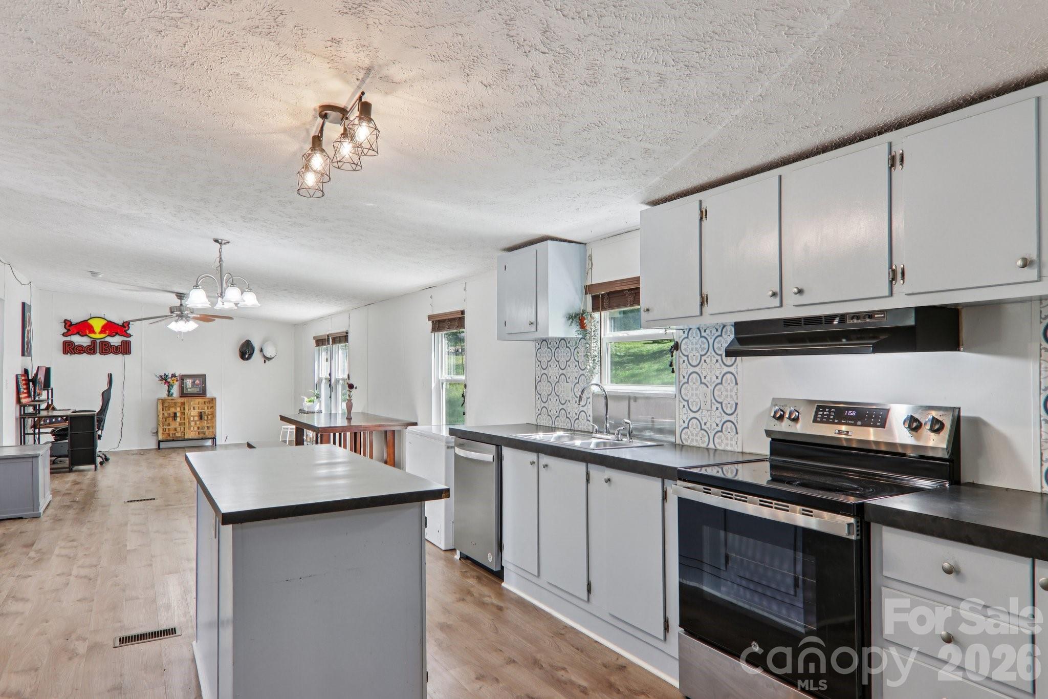 4 Sweet Birch Drive Alexander, NC 28701 - Photo 25 of 48 a kitchen with stainless steel appliances granite countertop a sink stove and cabinets