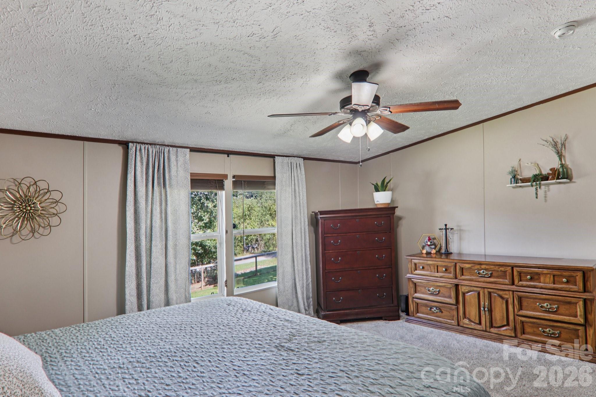 4 Sweet Birch Drive Alexander, NC 28701 - Photo 34 of 48 a bedroom with a bed and a chandelier