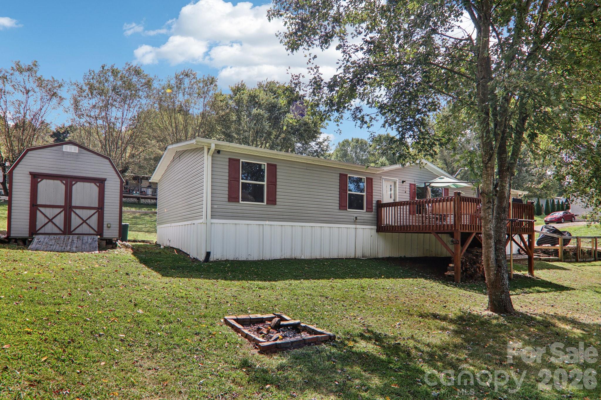 4 Sweet Birch Drive Alexander, NC 28701 - Photo 7 of 48 a backyard of a house with barbeque oven and outdoor seating