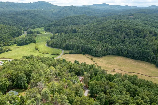 a kitchen with stainless steel appliances kitchen island granite countertop a table chairs sink and cabinets