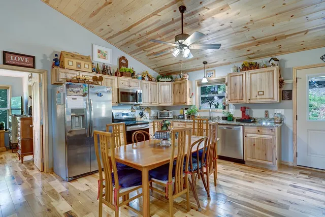 a view of a dining room with furniture and chandelier