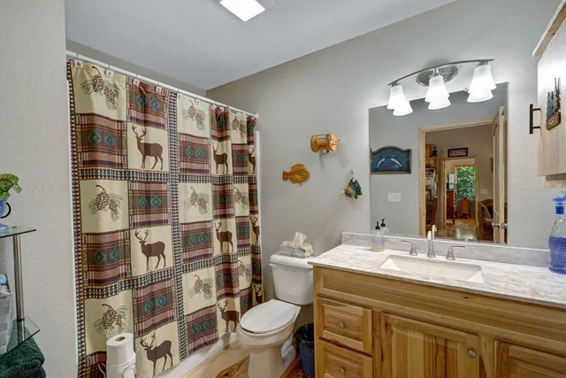 a bedroom with a bed and large windows