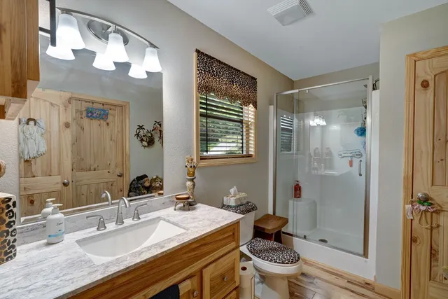 a view of a patio with a table and chairs under an umbrella with wooden floor