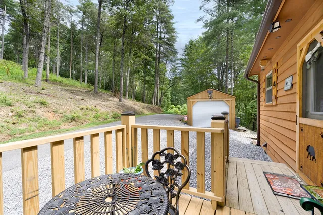 a view of a wooden deck and a backyard
