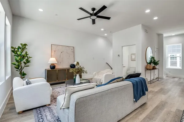 a living room with furniture and a potted plant