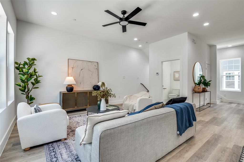 Living area featuring light wood finished floors, ceiling fan, and recessed lighting