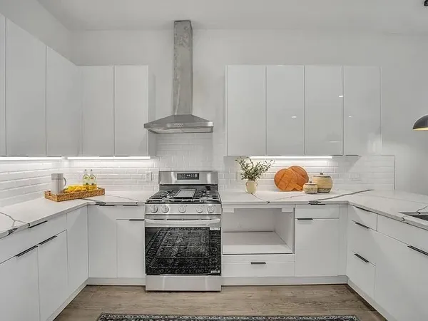 a kitchen with granite countertop a stove and a sink