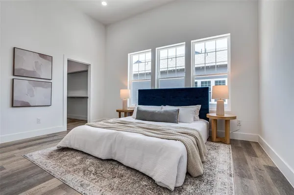 a bedroom with a large bed and a window