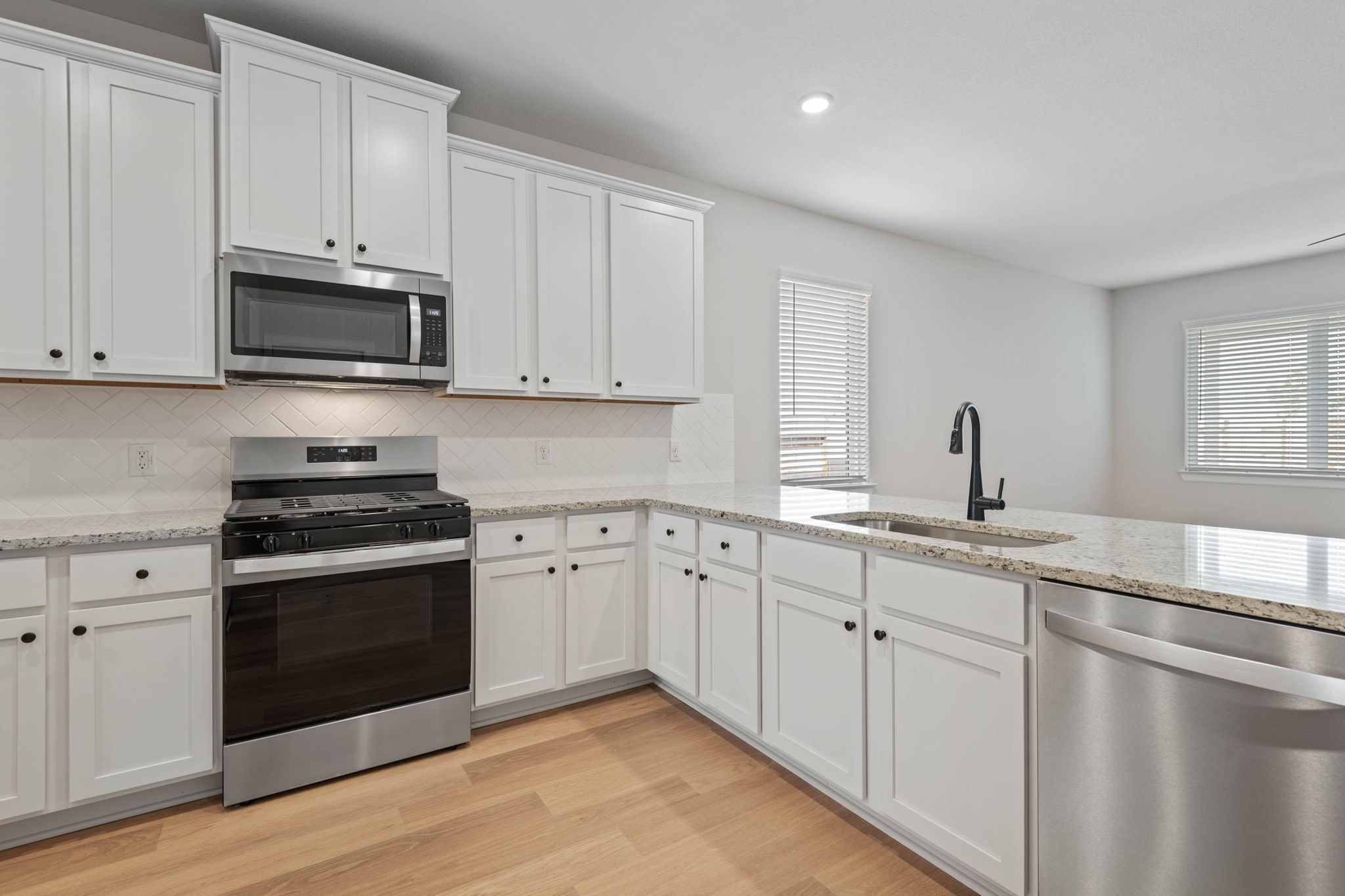 1139 Campside Drive Beasley, TX 77417 - Photo 5 of 18 a kitchen with granite countertop white cabinets and a stove
