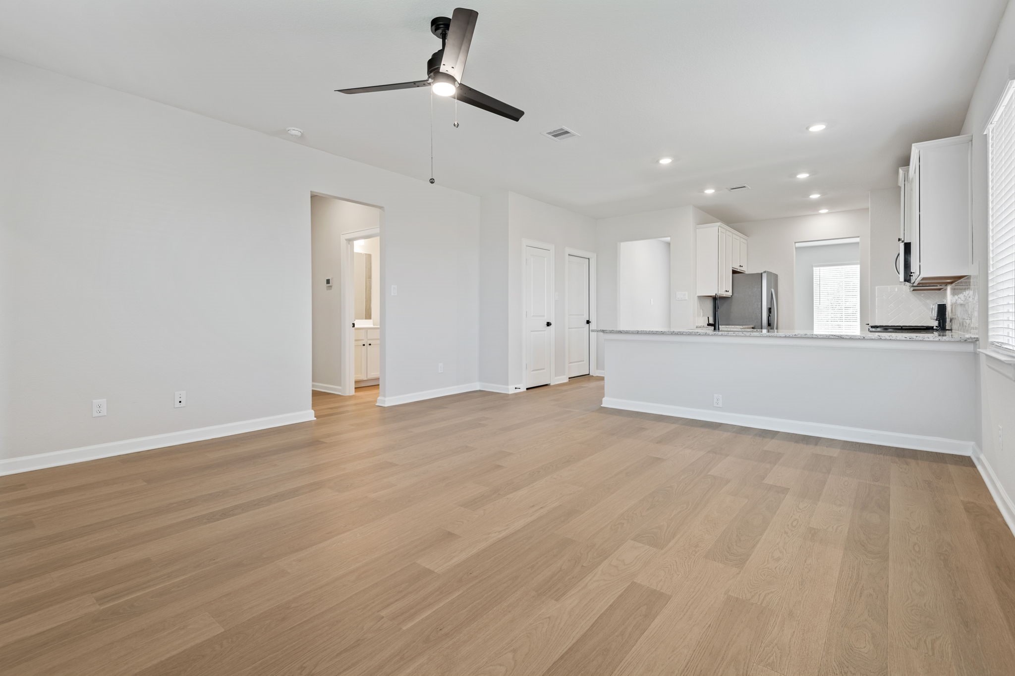 1139 Campside Drive Beasley, TX 77417 - Photo 10 of 18 an empty room with wooden floor and stainless steel appliances