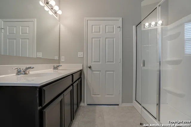a bathroom with a double vanity sink and a mirror