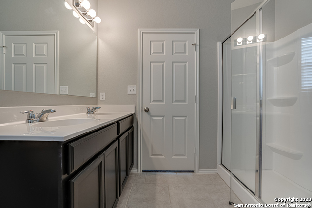 27319 Sterling Silver San Antonio, TX 78260 - Photo 19 of 28 a bathroom with a double vanity sink and a mirror