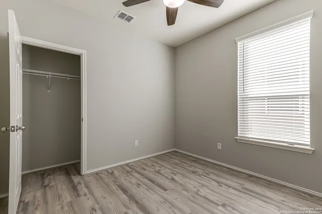 an empty room with a empty space and windows