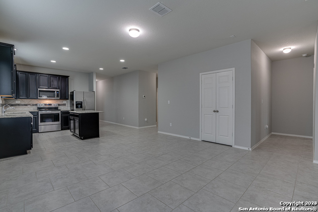 27319 Sterling Silver San Antonio, TX 78260 - Photo 5 of 28 a kitchen with stainless steel appliances granite countertop a refrigerator and a stove top oven