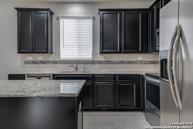 27319 Sterling Silver San Antonio, TX 78260 - Photo 9 of 28 a kitchen with granite countertop a sink stove and refrigerator