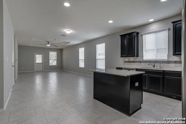 a kitchen with granite countertop a stove and a sink
