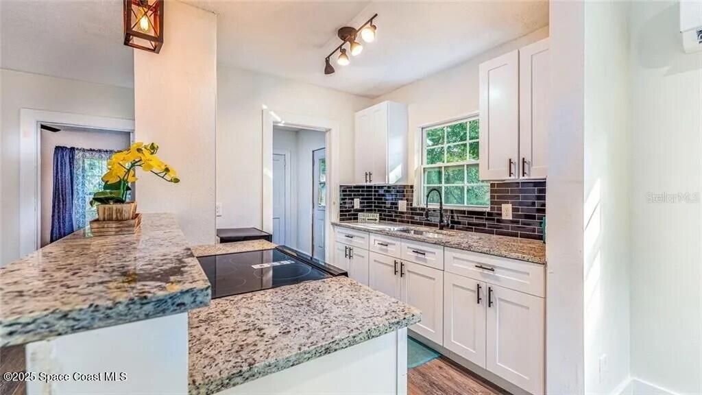 8812 Trevarthon Road Orlando, FL 32817 - Photo 14 of 22 a kitchen with stainless steel appliances granite countertop sink stove and refrigerator