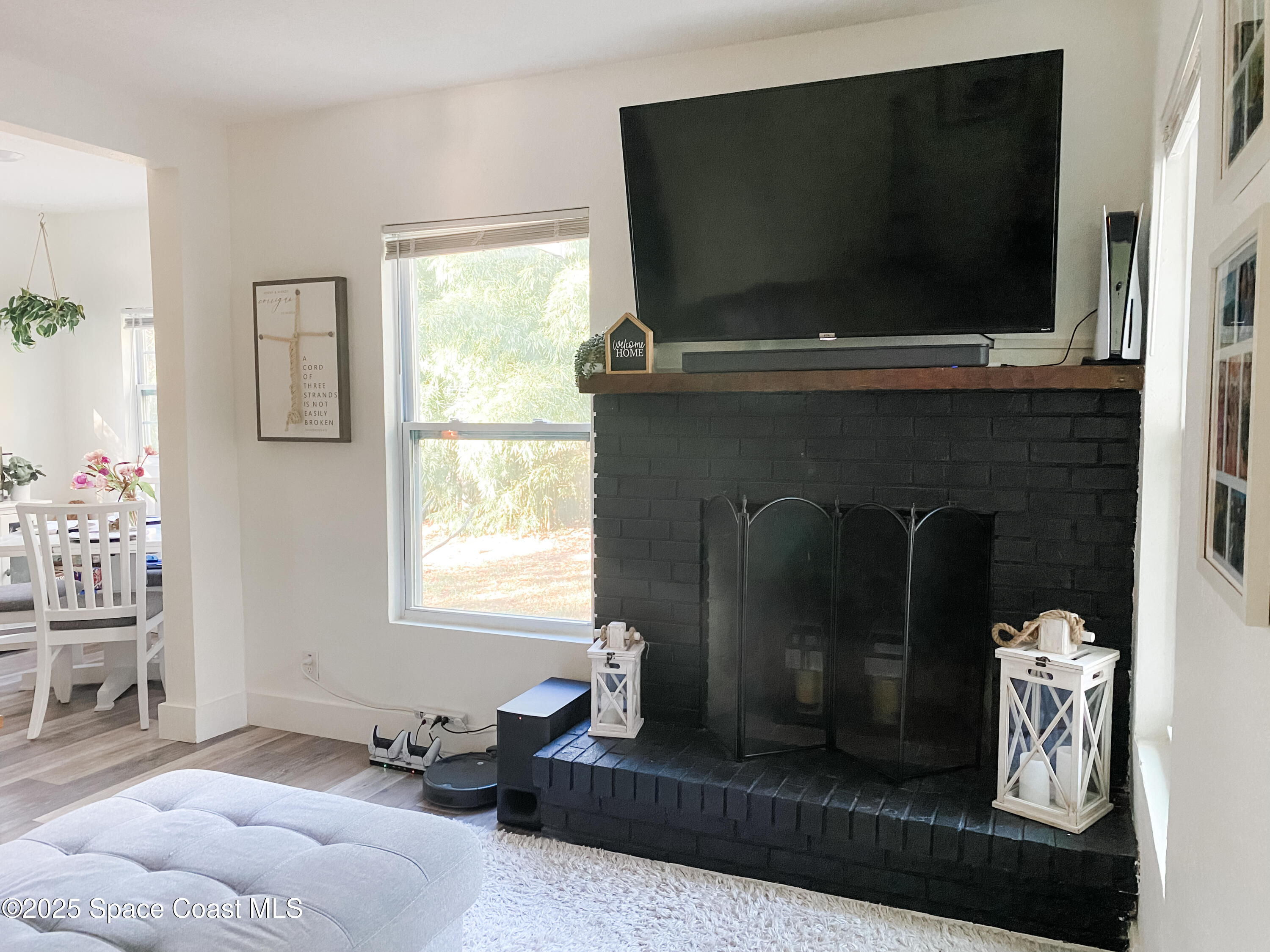 8812 Trevarthon Road Orlando, FL 32817 - Photo 15 of 22 a living room with furniture a flat screen tv and a fireplace