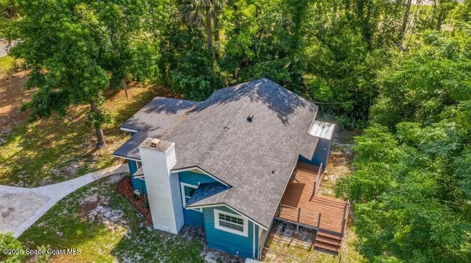 8812 Trevarthon Road Orlando, FL 32817 - Photo 2 of 22 an aerial view of a house with a yard and tree s