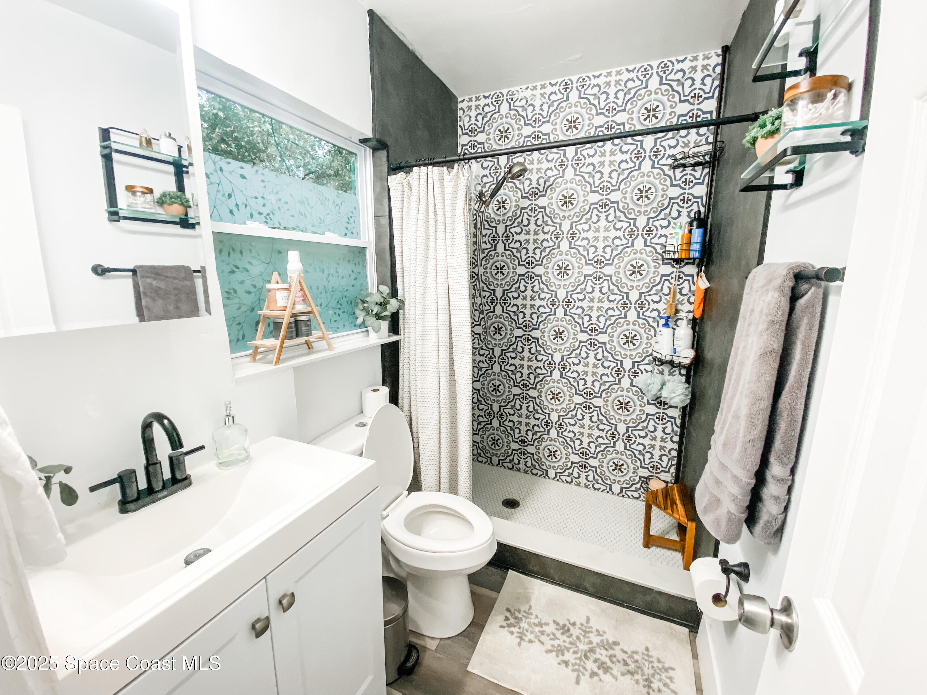 8812 Trevarthon Road Orlando, FL 32817 - Photo 8 of 22 a bathroom with a sink toilet and shower