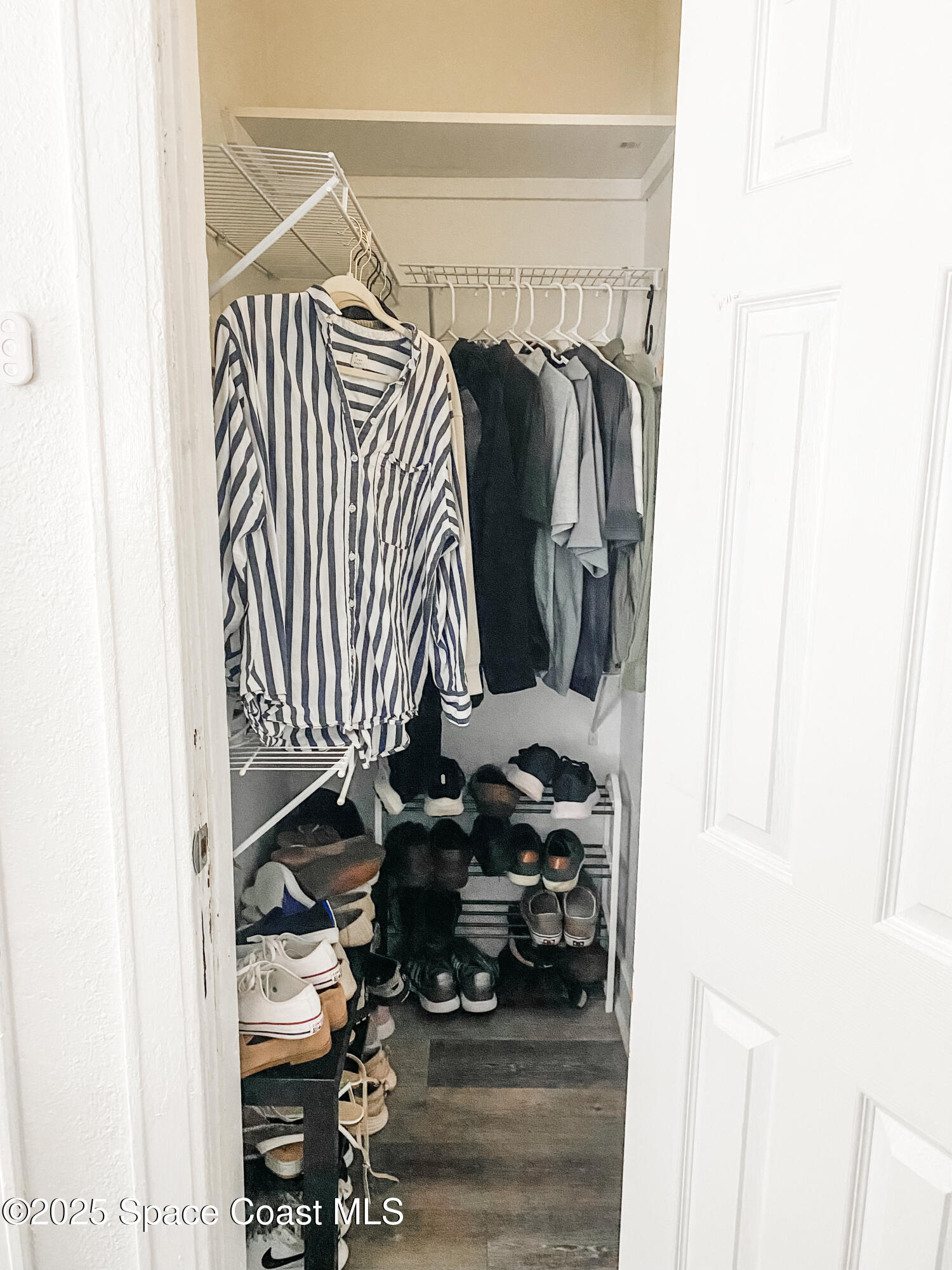 8812 Trevarthon Road Orlando, FL 32817 - Photo 9 of 22 a view of walk in closet with clothes and shoes