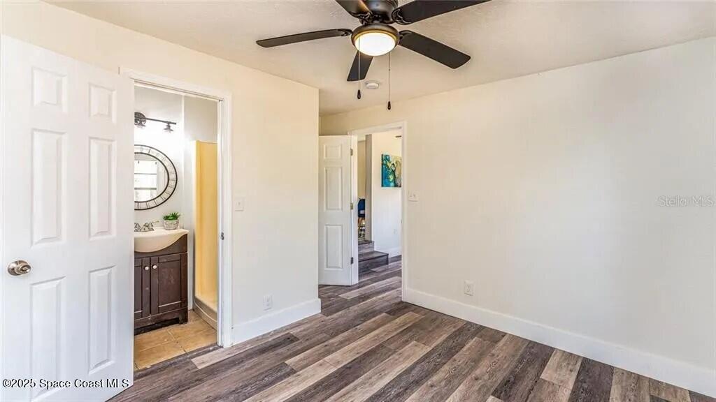 8812 Trevarthon Road Orlando, FL 32817 - Photo 10 of 22 a view of a hallway with wooden floor and staircase