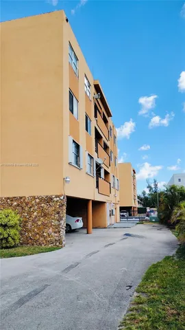 a view of building with parking area