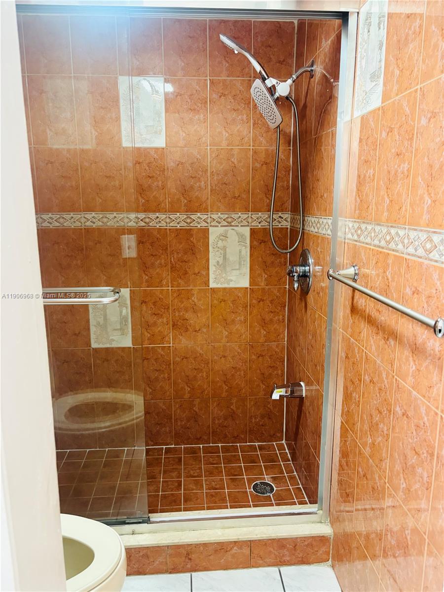 295 Northwest 72nd Avenue, Unit 401 Miami, FL 33126 - Photo 6 of 12 a bathroom with a shower