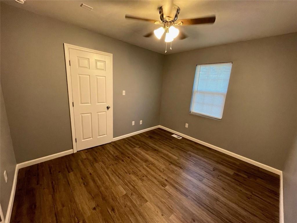 458 Daffodil Street Macon, GA 31204 - Photo 22 of 24 an empty room with wooden floor fan and windows