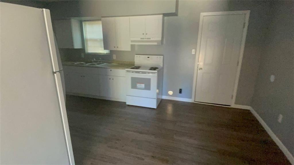 458 Daffodil Street Macon, GA 31204 - Photo 4 of 24 a view of a kitchen with white cabinets and wooden floor