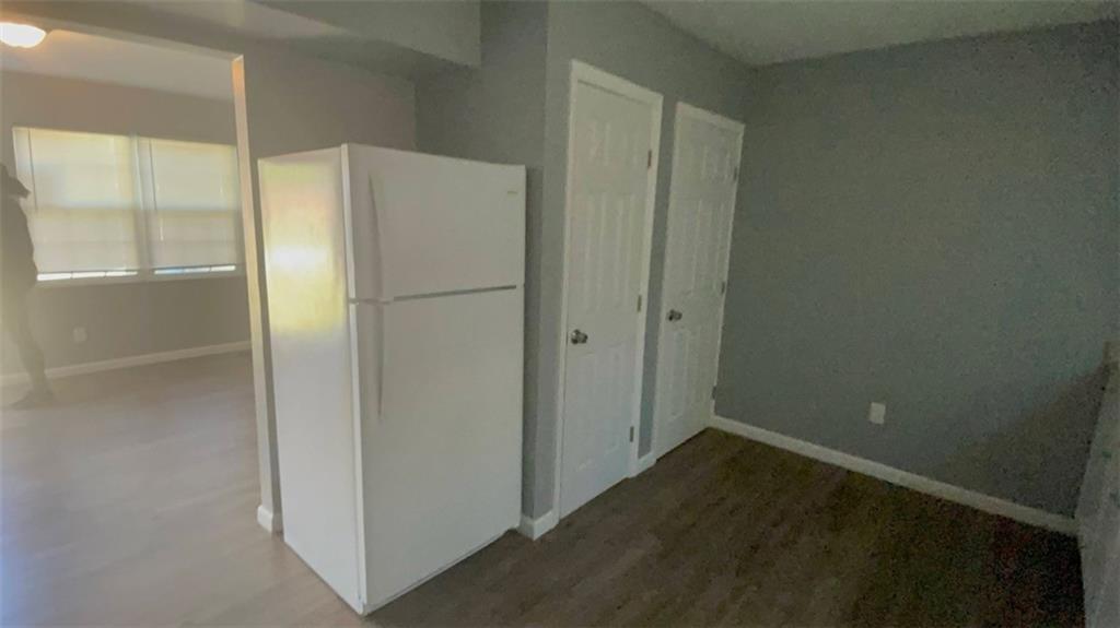 458 Daffodil Street Macon, GA 31204 - Photo 6 of 24 a view of a refrigerator in kitchen and an empty room