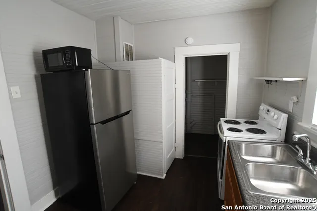 a kitchen with a refrigerator and a sink