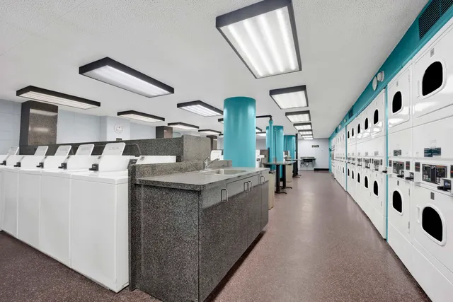 a large white kitchen with a lot of counter space