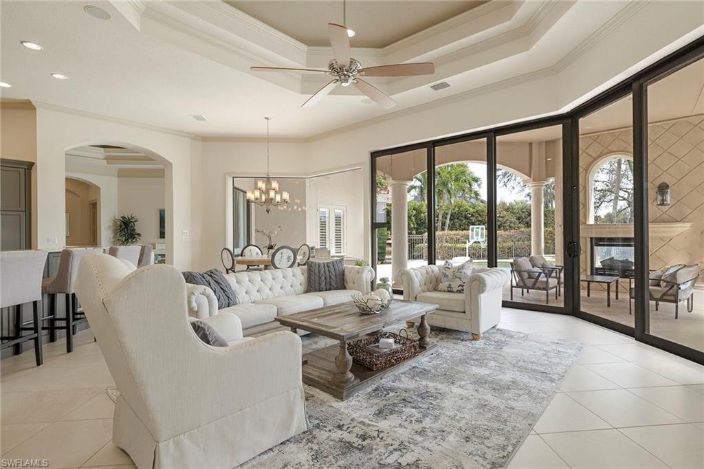 16540 Cellini Lane Naples, FL 34110 - Photo 15 of 50 a living room with furniture and large windows