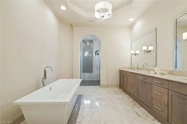 a spacious bathroom with a double vanity sink a mirror and a bathtub