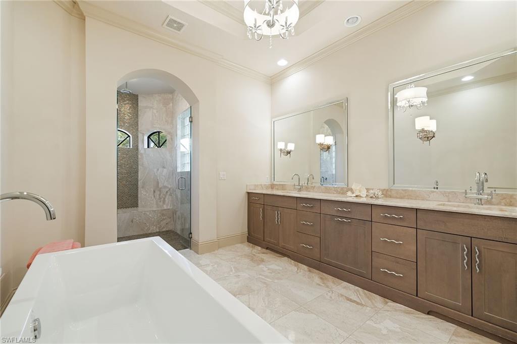 16540 Cellini Lane Naples, FL 34110 - Photo 19 of 50 a spacious bathroom with a double vanity sink shower and a mirror
