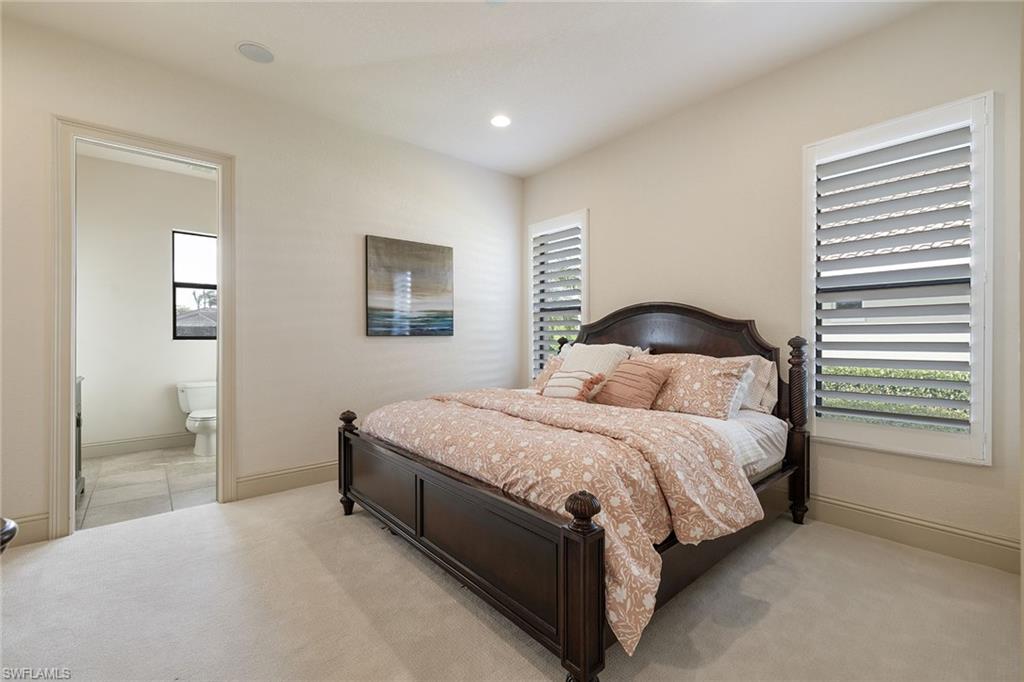 16540 Cellini Lane Naples, FL 34110 - Photo 23 of 50 a bedroom with a bed and a painting