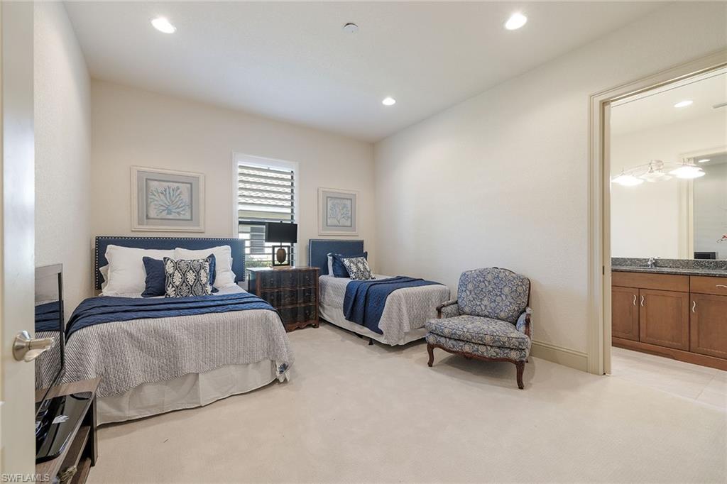 16540 Cellini Lane Naples, FL 34110 - Photo 25 of 50 a spacious bedroom with a bed and a couch