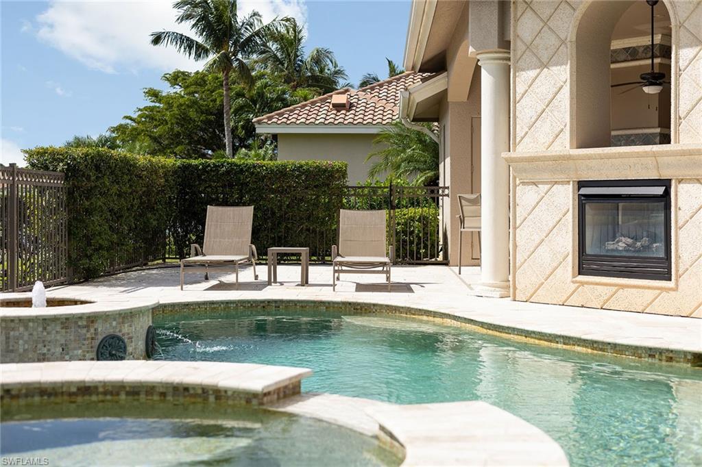 16540 Cellini Lane Naples, FL 34110 - Photo 33 of 50 a view of a swimming pool with a patio