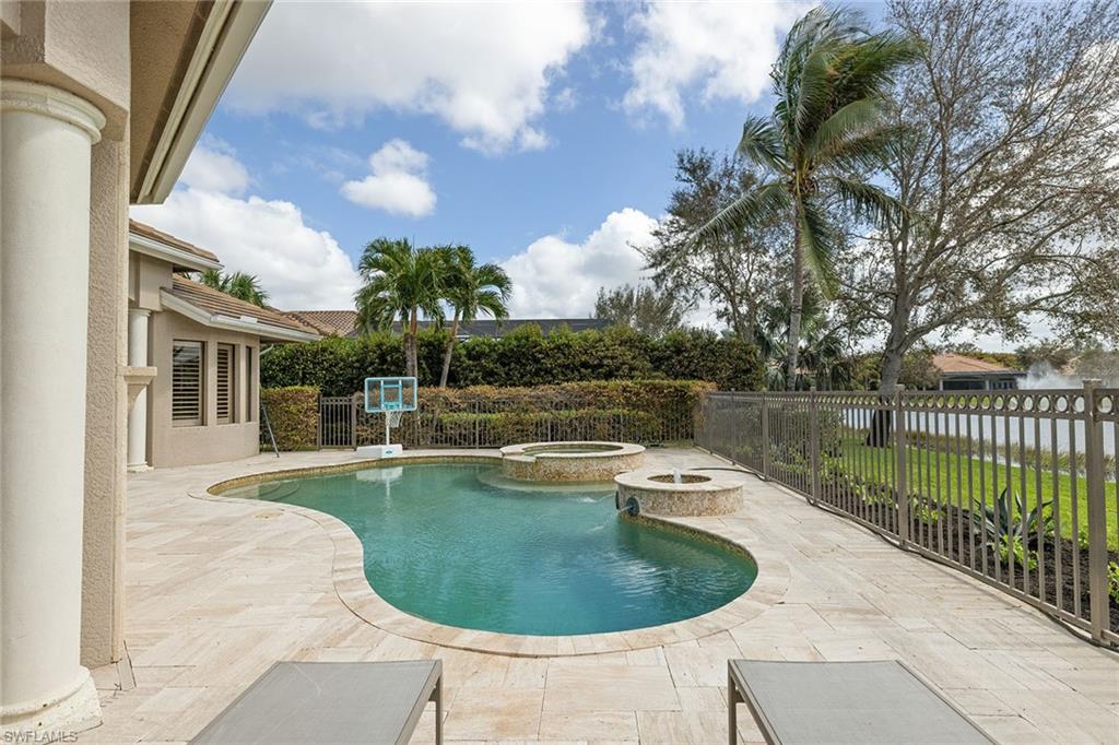 16540 Cellini Lane Naples, FL 34110 - Photo 35 of 50 a view of a swimming pool with a yard in back