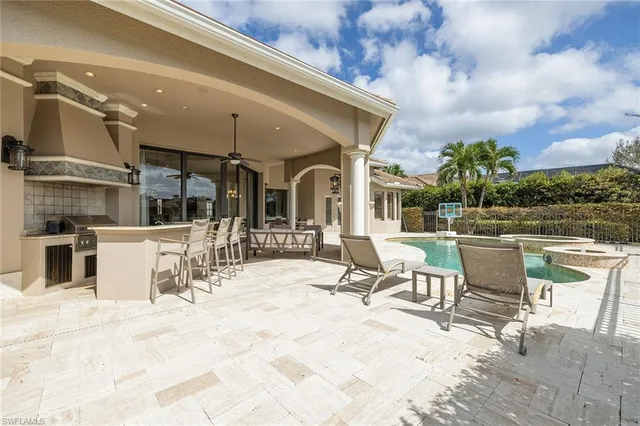 a view of a patio with table and chairs with wooden floor and plants