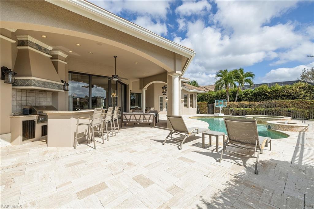 16540 Cellini Lane Naples, FL 34110 - Photo 36 of 50 a view of a patio with table and chairs with wooden floor and plants