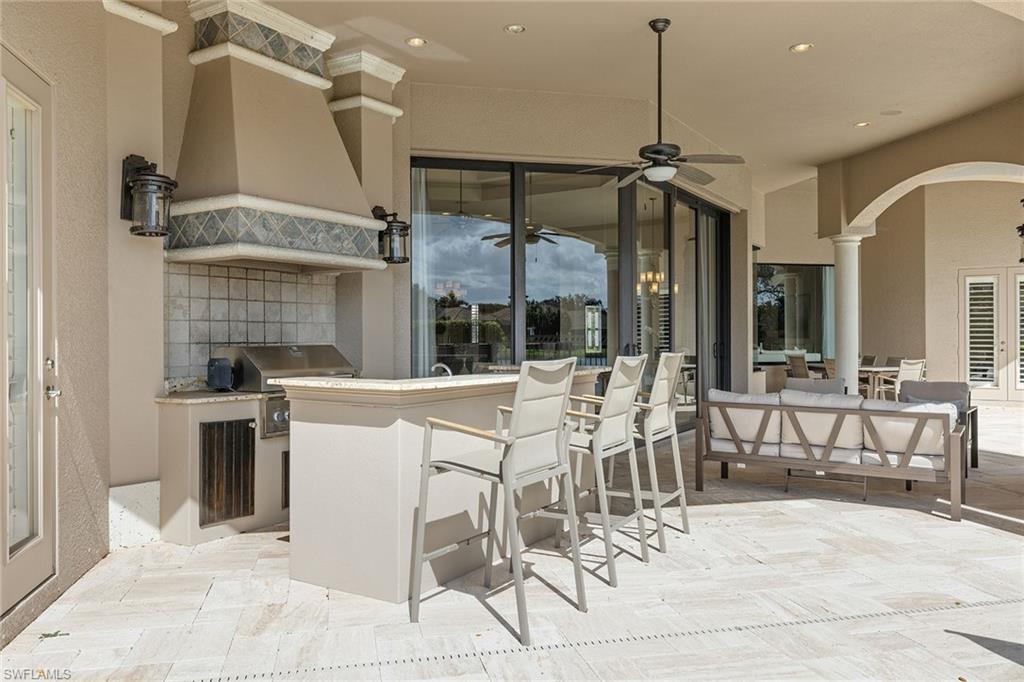 16540 Cellini Lane Naples, FL 34110 - Photo 38 of 50 a patio with a table and chairs