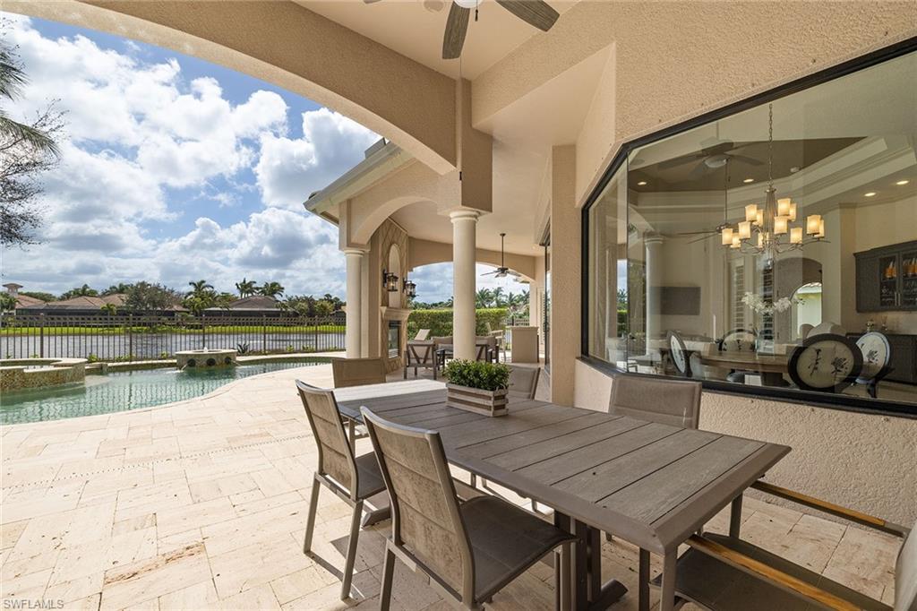 16540 Cellini Lane Naples, FL 34110 - Photo 41 of 50 a patio with lake view and city view