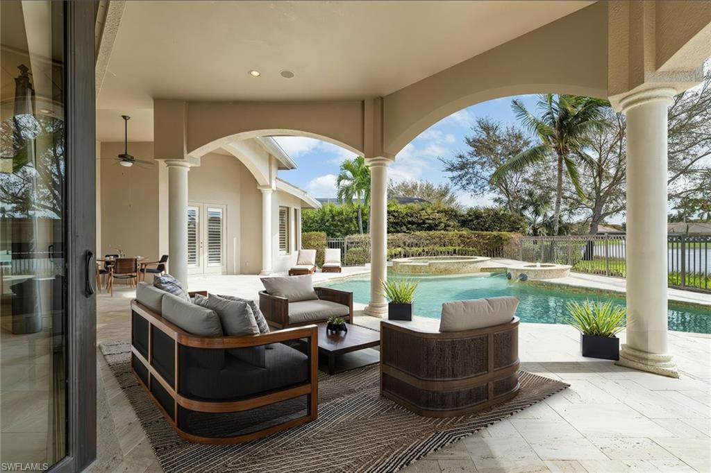 16540 Cellini Lane Naples, FL 34110 - Photo 42 of 50 a outdoor space with patio the couches and a dining table with garden view