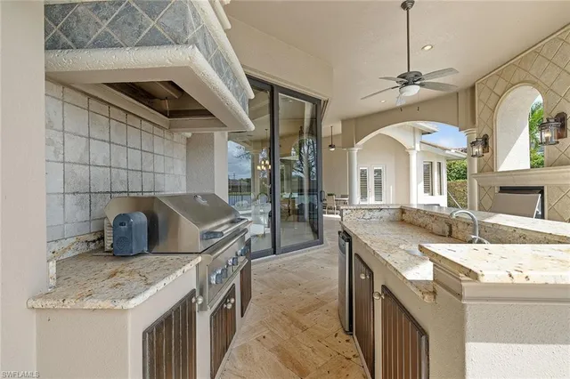 a kitchen with granite countertop a sink a counter top space and cabinets