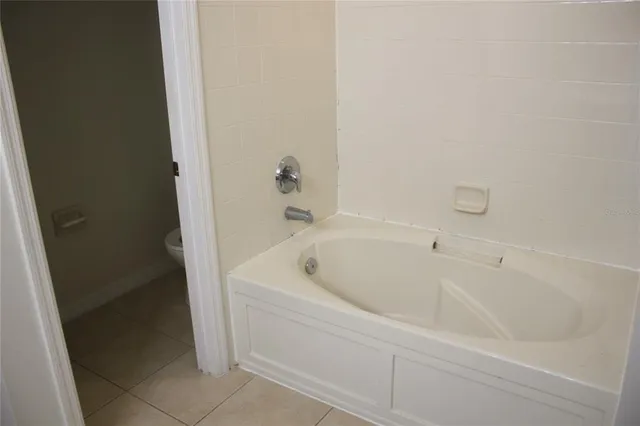 a white bath tub sitting next to a white sink