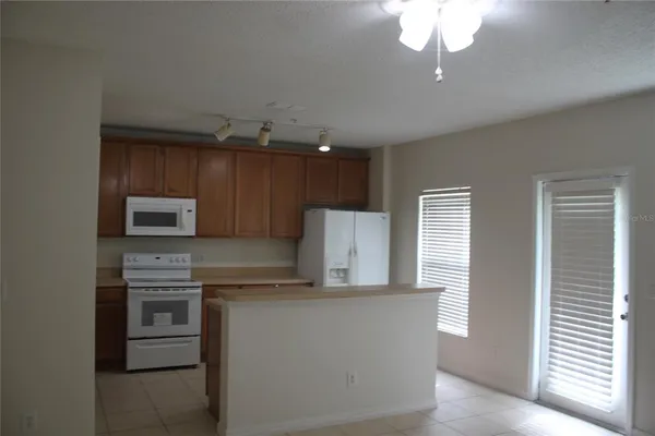 a kitchen with kitchen island granite countertop stainless steel appliances and cabinets
