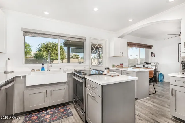 a kitchen with a sink stove and cabinets